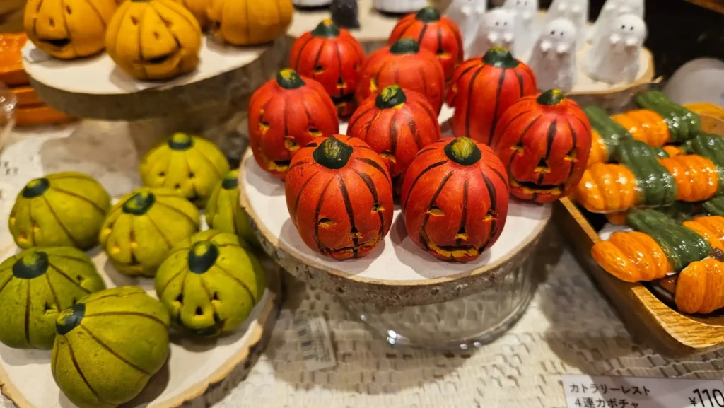 Japanese fall decor with orange and green pumpkins and autumn decorations